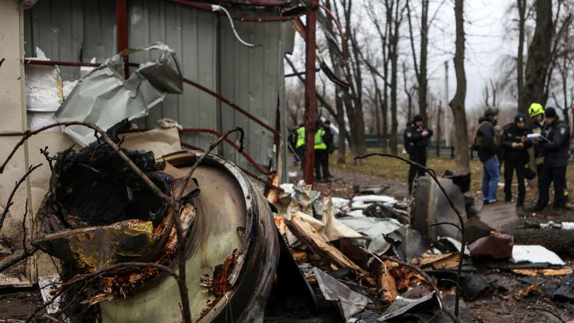 Firefighter extinguishes remains of an unidentified missile, which Ukrainian authorities claimed to be made in North Korea, at a site of a Russian strike in Kharkiv