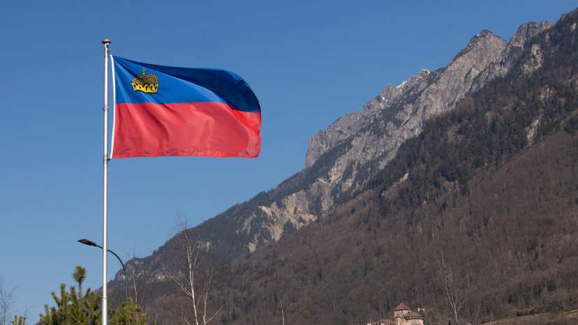 A flag of the Principality of Liechtenstein is seen near Vaduz