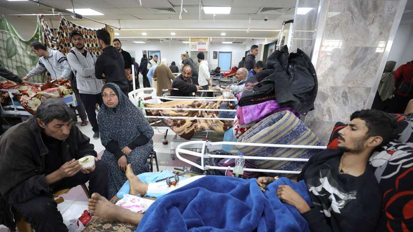 Palestinians who were wounded in Israeli fire while waiting for aid, according to health officials, lie on beds at Al Shifa hospital, amid the ongoing conflict between Israel and Hamas, in Gaza City