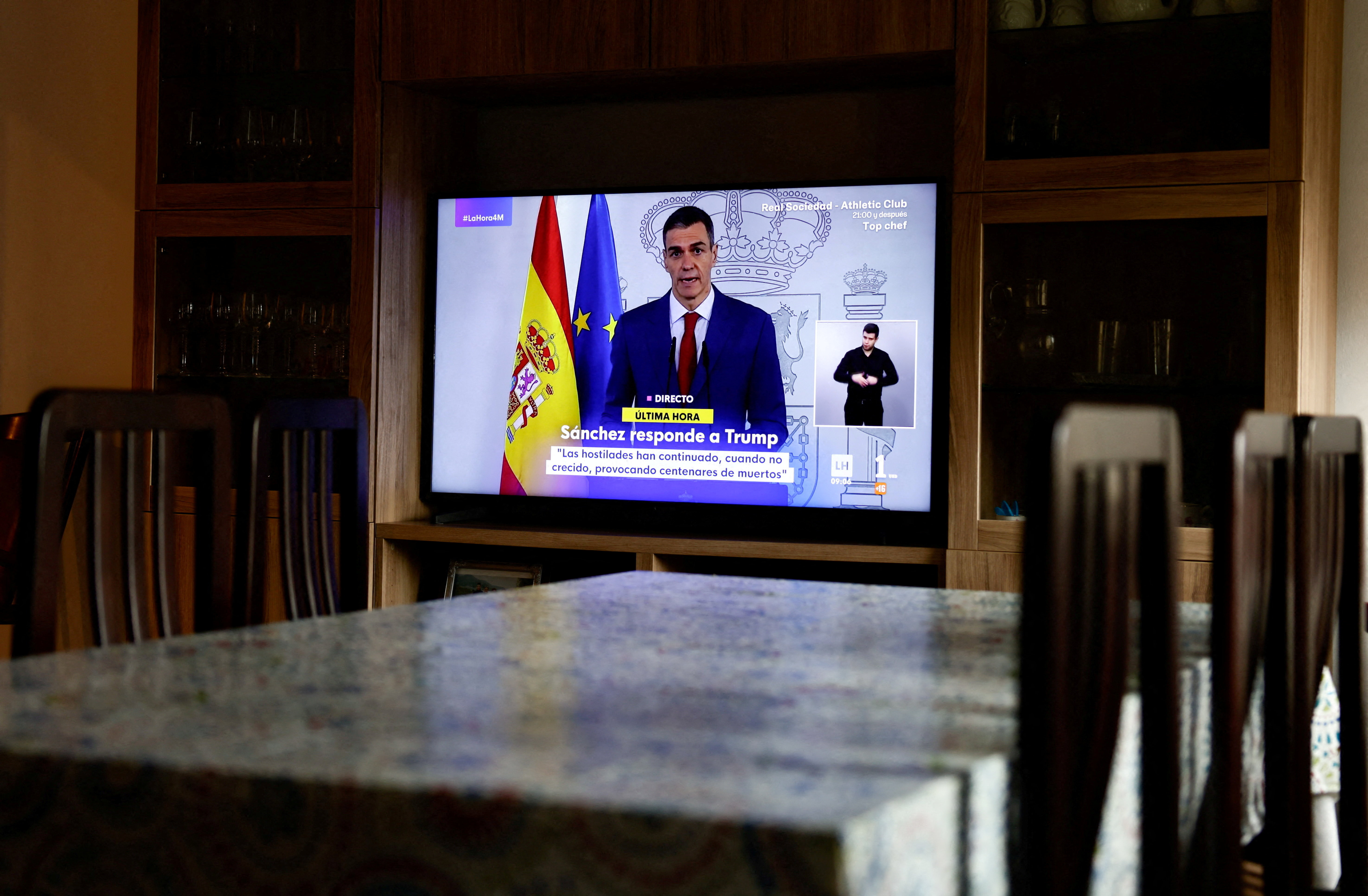 TV screen shows live broadcast of Spain's Prime Minister Pedro Sanchez delivering a statement, at a house in Ronda