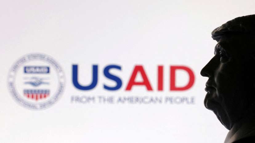 FILE PHOTO: Illustration shows 3D-printed miniature model of U.S. President Trump and USAID logo