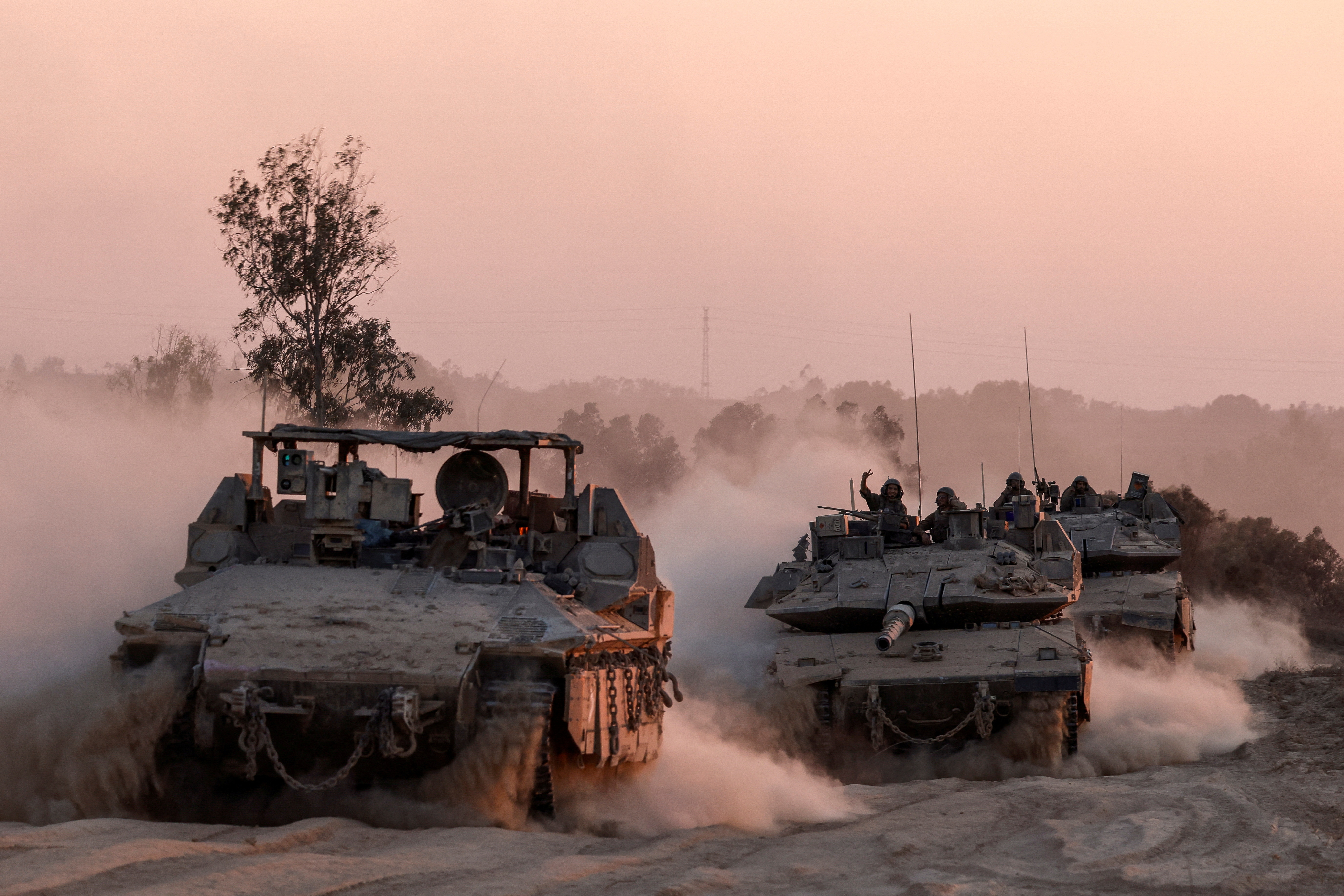 Israeli military vehicles manoeuvre, near the Israel-Gaza border