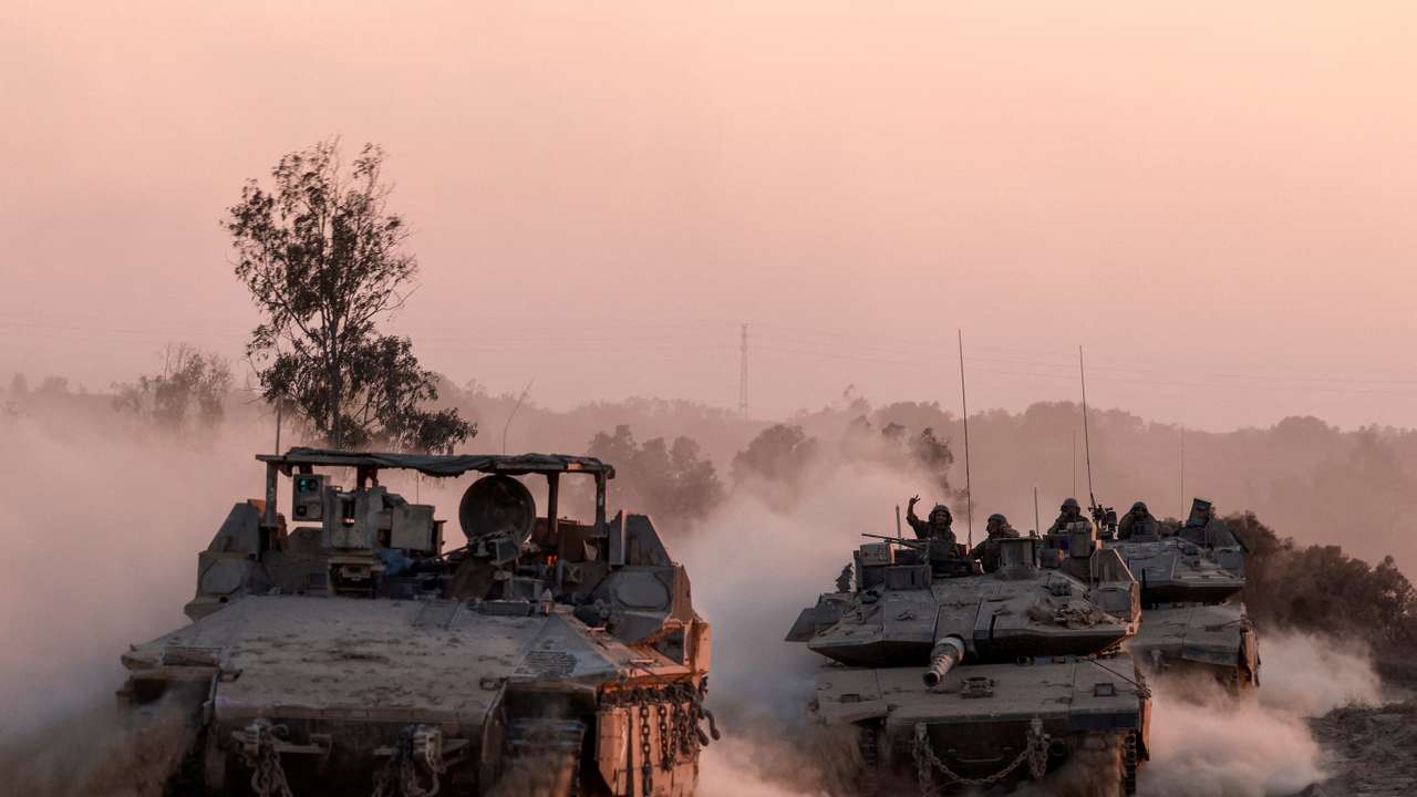Israeli military vehicles manoeuvre, near the Israel-Gaza border