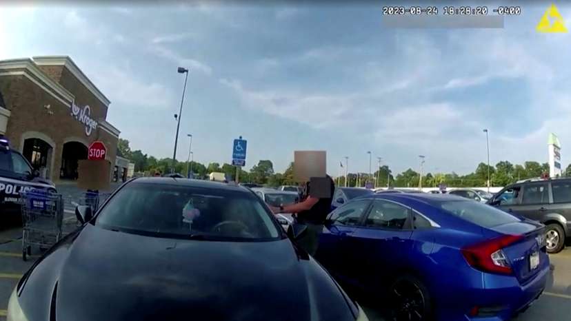 Screen capture obtained from a body camera footage showing an officer fatally shooting a pregnant Black woman in the parking lot of a grocery store in Blendon