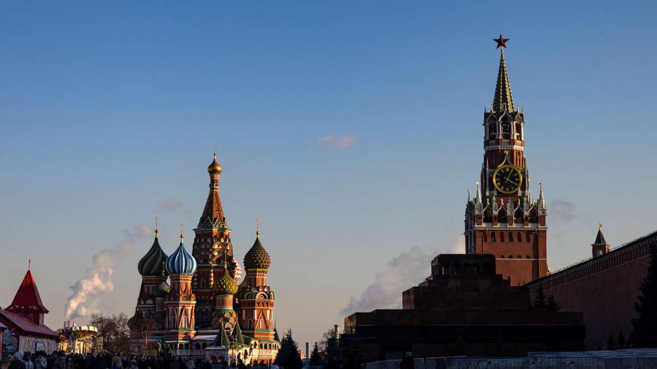 People walk in Red Square on a sunny day in Moscow