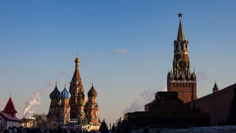 People walk in Red Square on a sunny day in Moscow