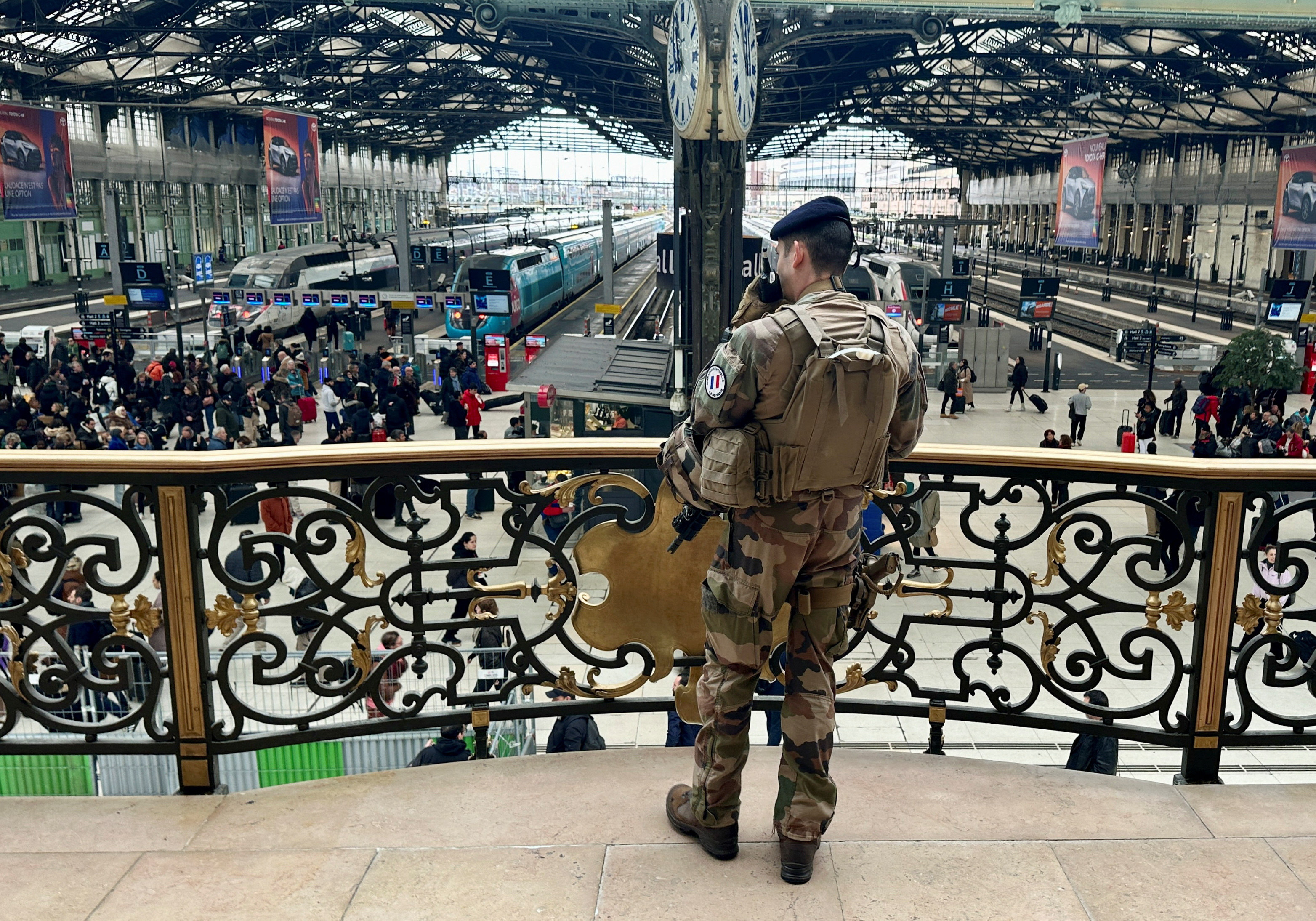 Officers secure the area at a rail station after a knife attack in Paris