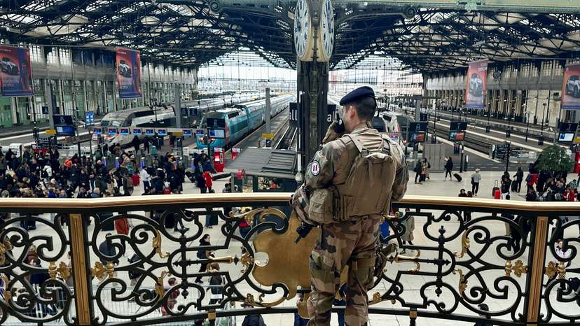 Officers secure the area at a rail station after a knife attack in Paris