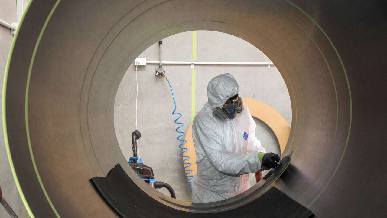 FILE PHOTO: A Rocket Lab technician cleans a fuselage in Auckland, New Zealand