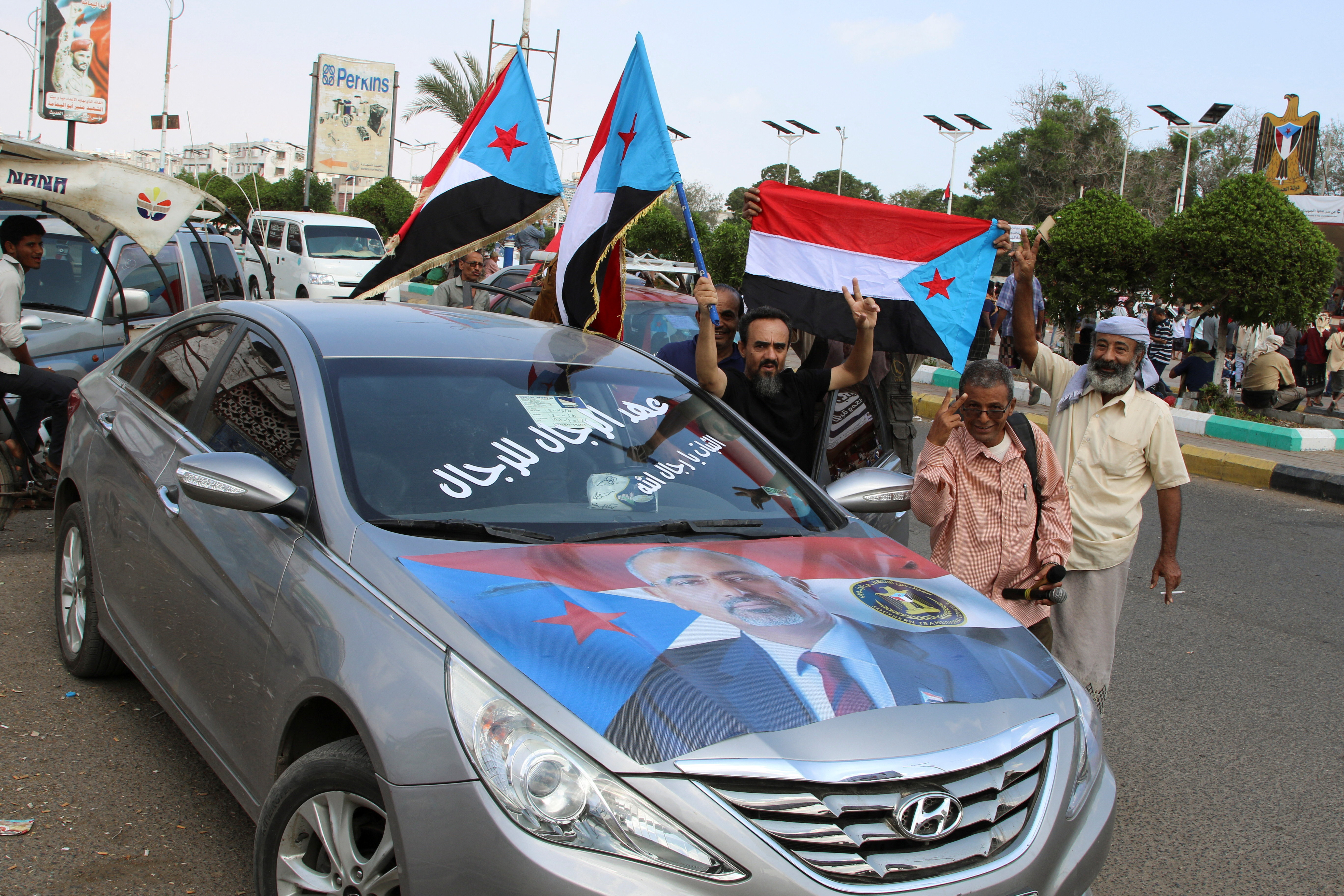 Supporters of the UAE-backed separatist group, Southern Transitional Council, wave flags in Aden
