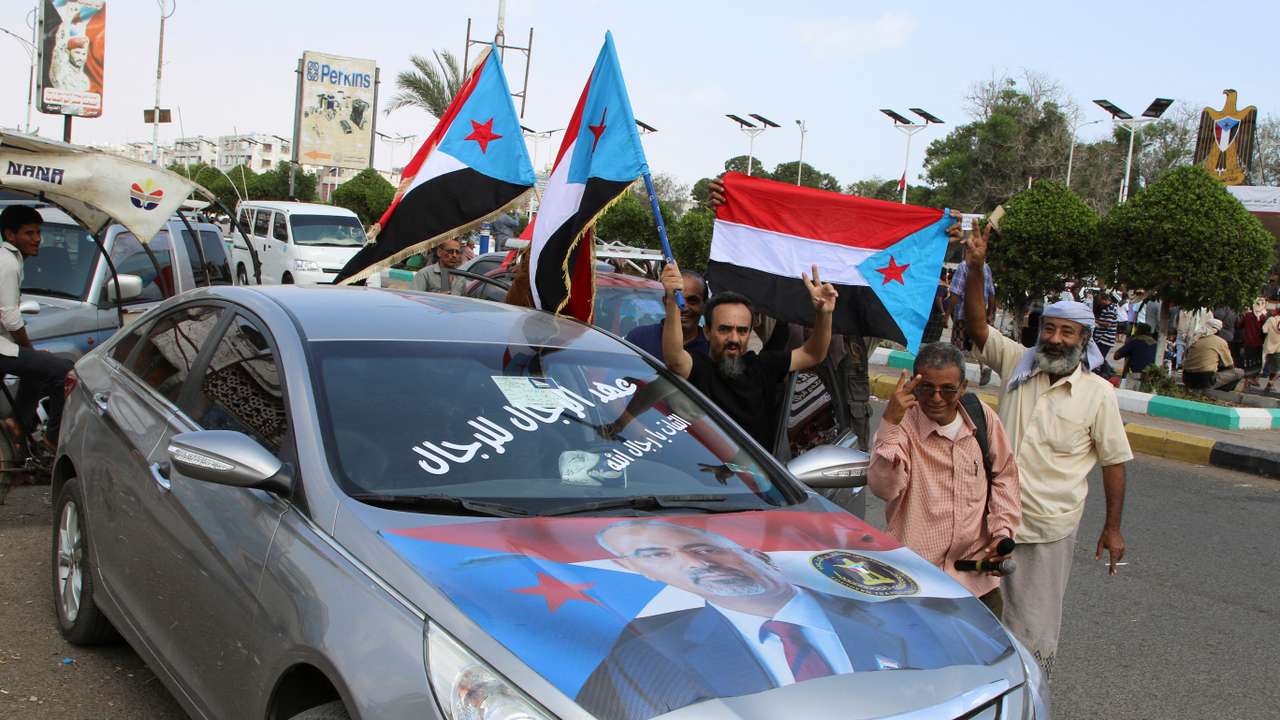 Supporters of the UAE-backed separatist group, Southern Transitional Council, wave flags in Aden