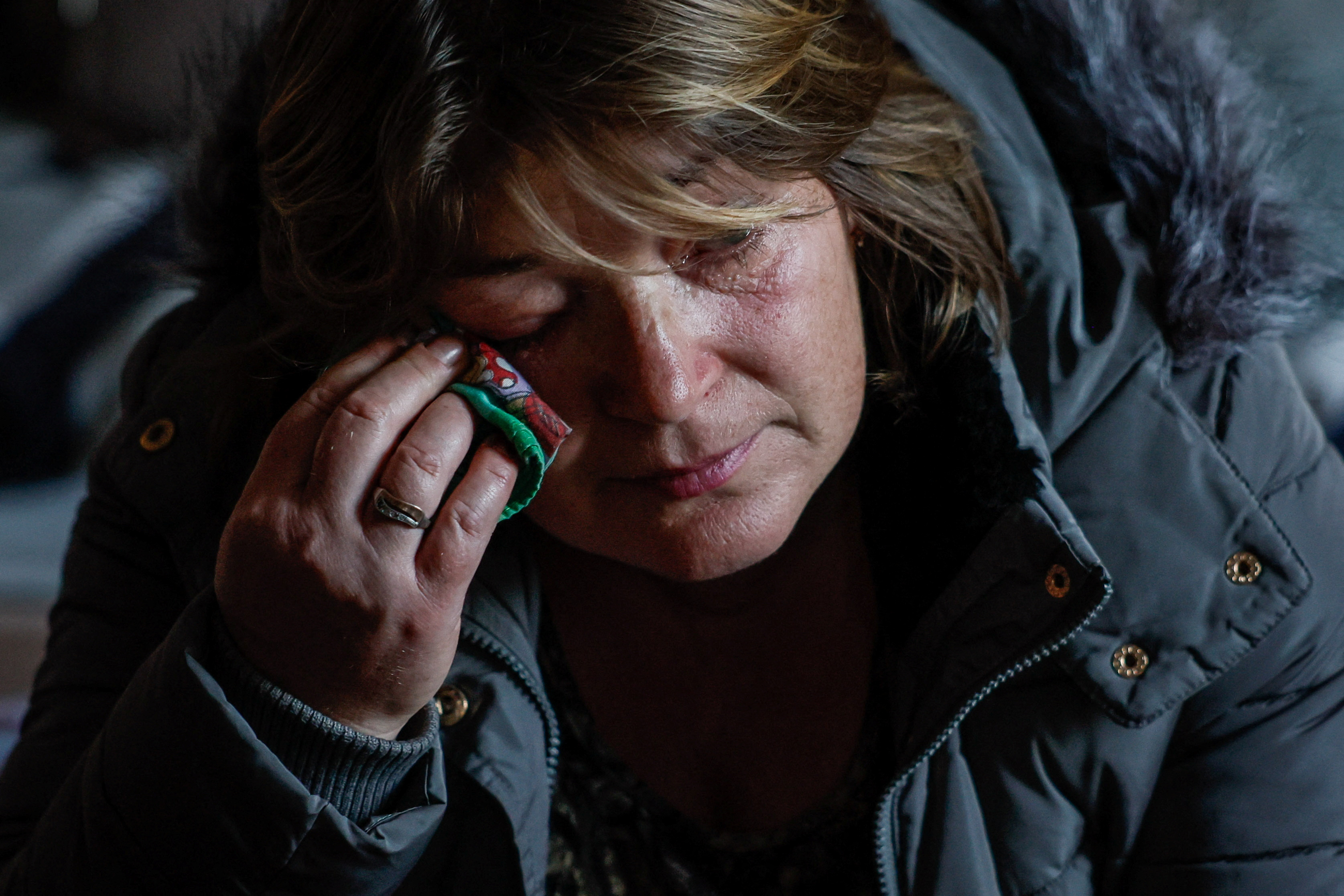 Woman, an IDP from the town of Toretsk, reacts after evacuation at a temporary shelter in Kostiantynivka