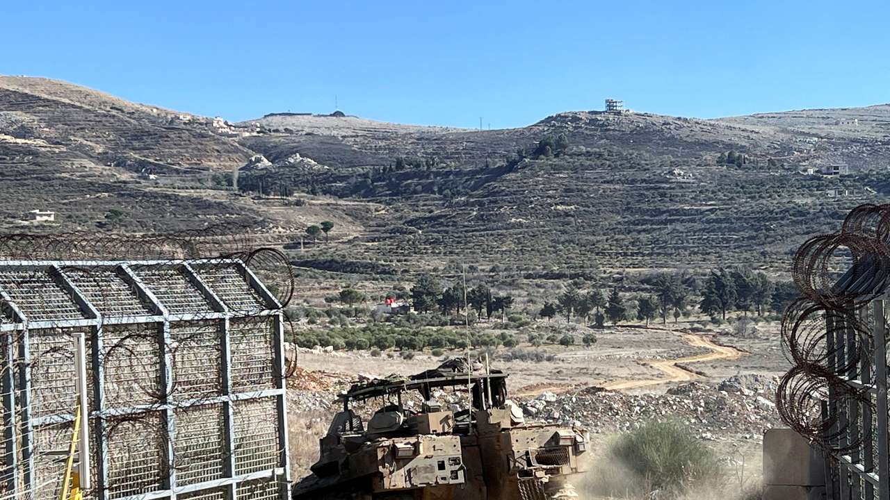 An Israeli APC enters Syria at the ceasefire line with Syria and the Israeli-occupied Golan Heights, as seen from the Golan Heights