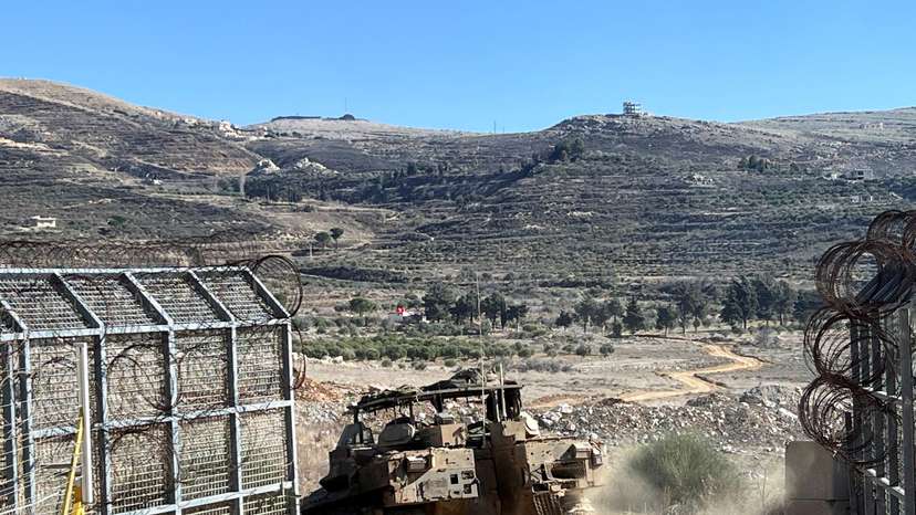 An Israeli APC enters Syria at the ceasefire line with Syria and the Israeli-occupied Golan Heights, as seen from the Golan Heights