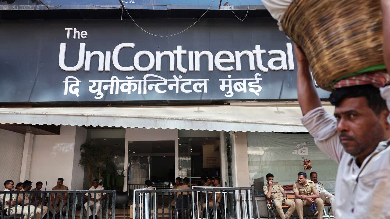 Police officers sit outside The Habitat, a studio where Kunal Kamra performed, in Mumbai