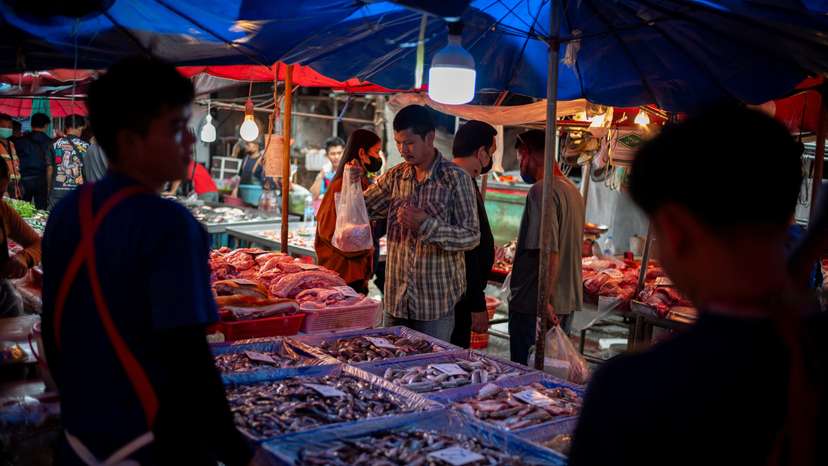 A man buys foods at a market as Thailand is to inject $15.2 bln into economy next year through its digital wallet policy, in Bangkok