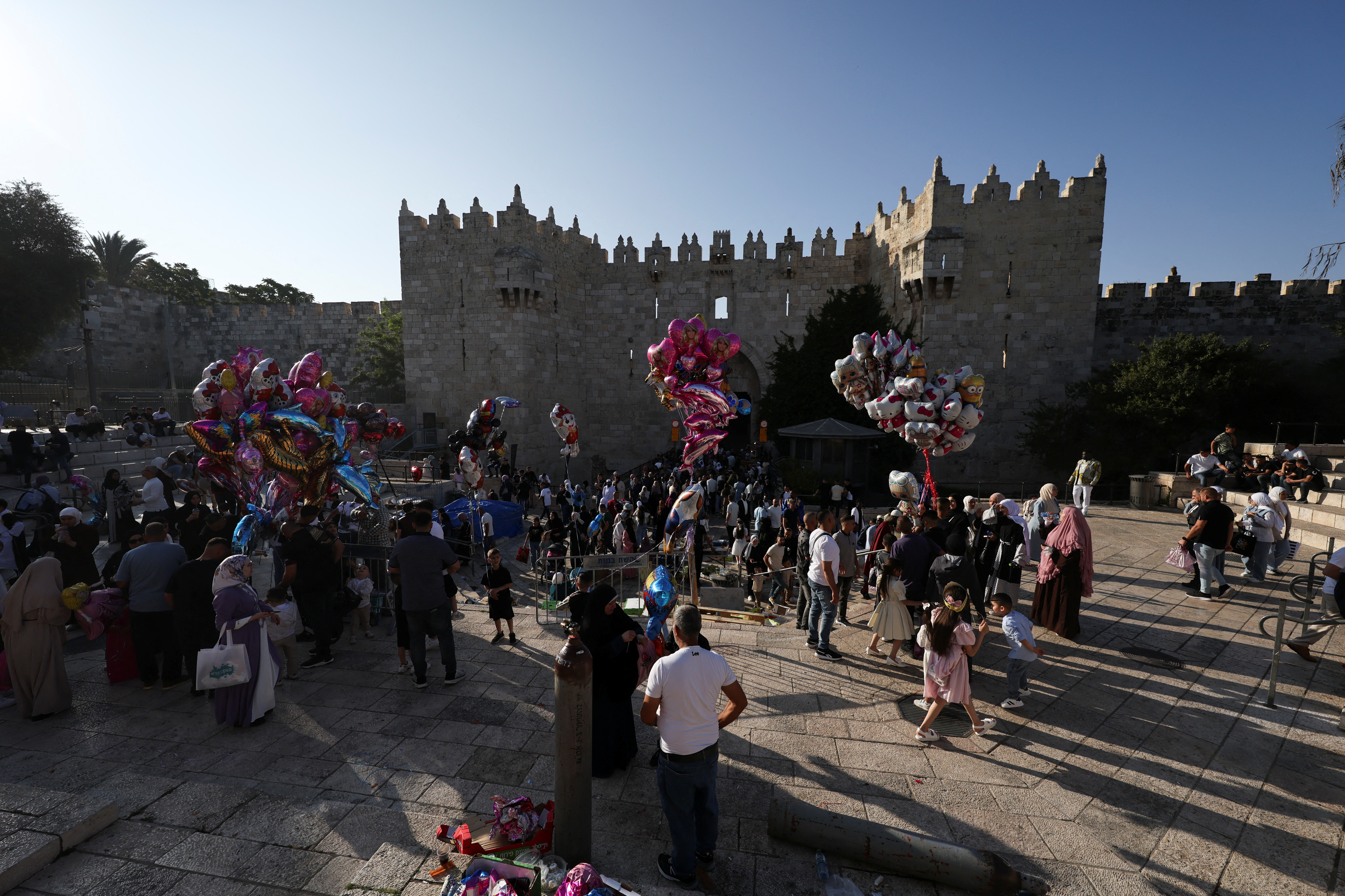 People gather near the Damascus gate on the first day of the Muslim holiday of Eid al-Adha, in Jerusalem's Old City
