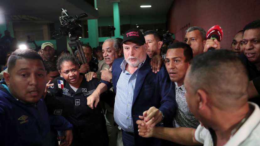 Panama's former president Ricardo Martinelli is escorted by police officers and supporters while leaving a courthouse after being declared not guilty of spying charges in Panama City