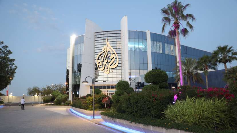 FILE PHOTO: Man walks near an Al Jazeera building in Doha