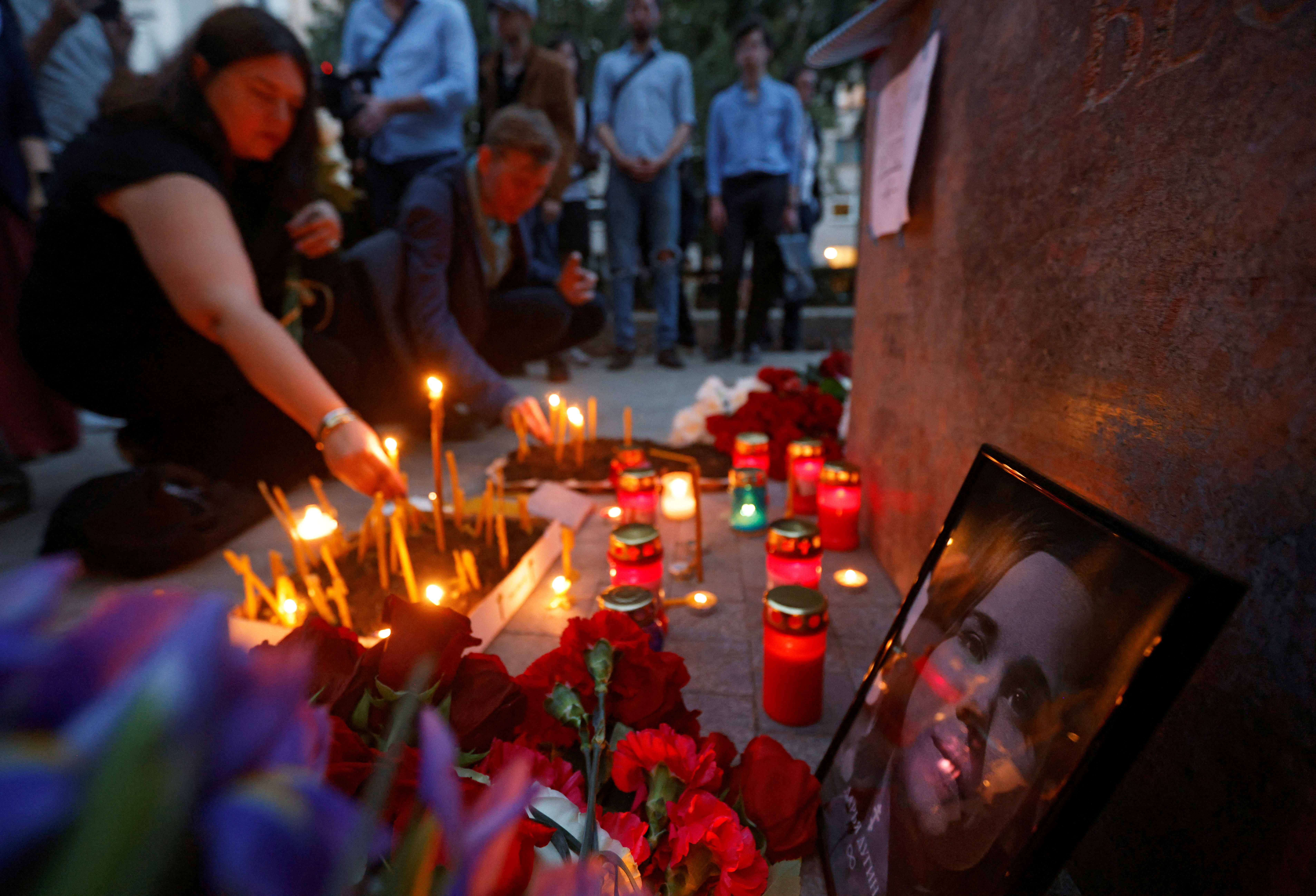 FILE PHOTO: Flowers and candles are placed next to a portrait of Darya Dugina in Moscow