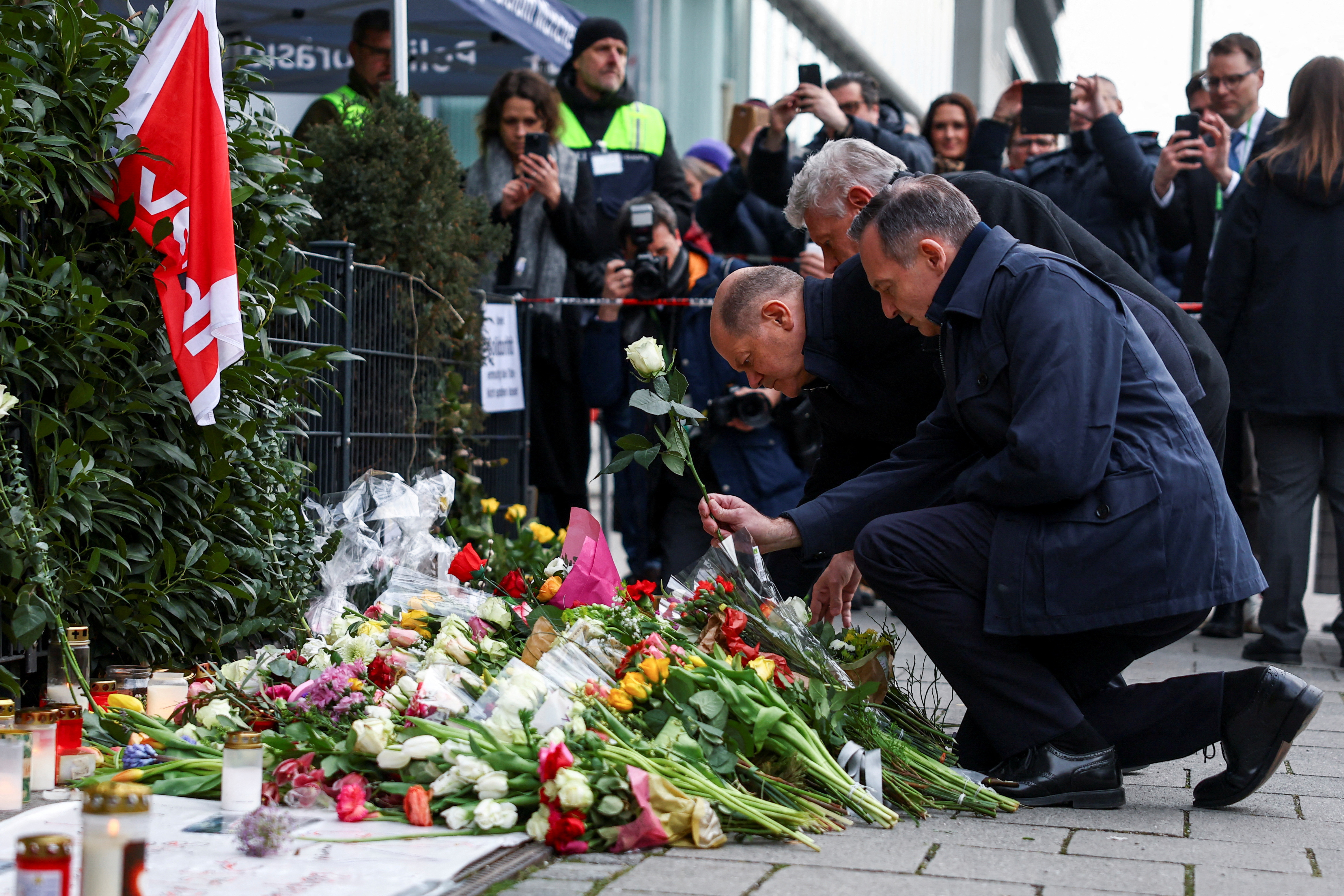 German Chancellor Scholz visits a makeshift memorial for the victims of a suspected ramming attack, in Munich