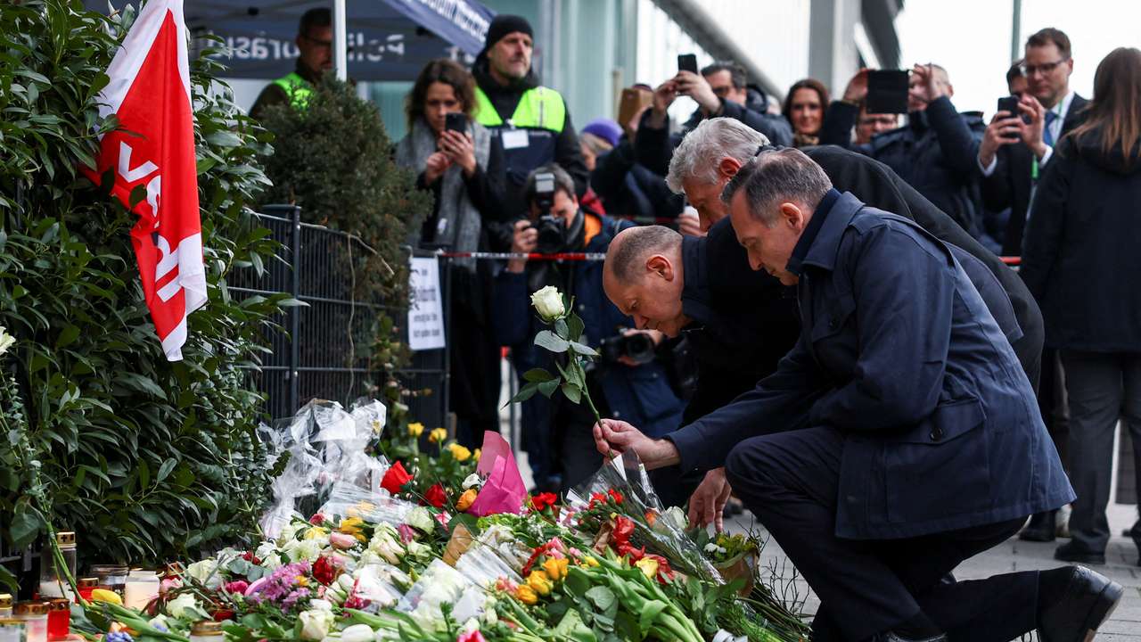 German Chancellor Scholz visits a makeshift memorial for the victims of a suspected ramming attack, in Munich