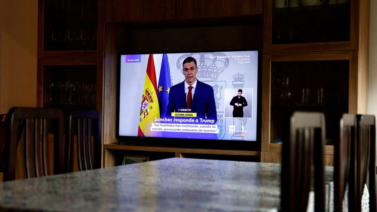 TV screen shows live broadcast of Spain's Prime Minister Pedro Sanchez delivering a statement, at a house in Ronda