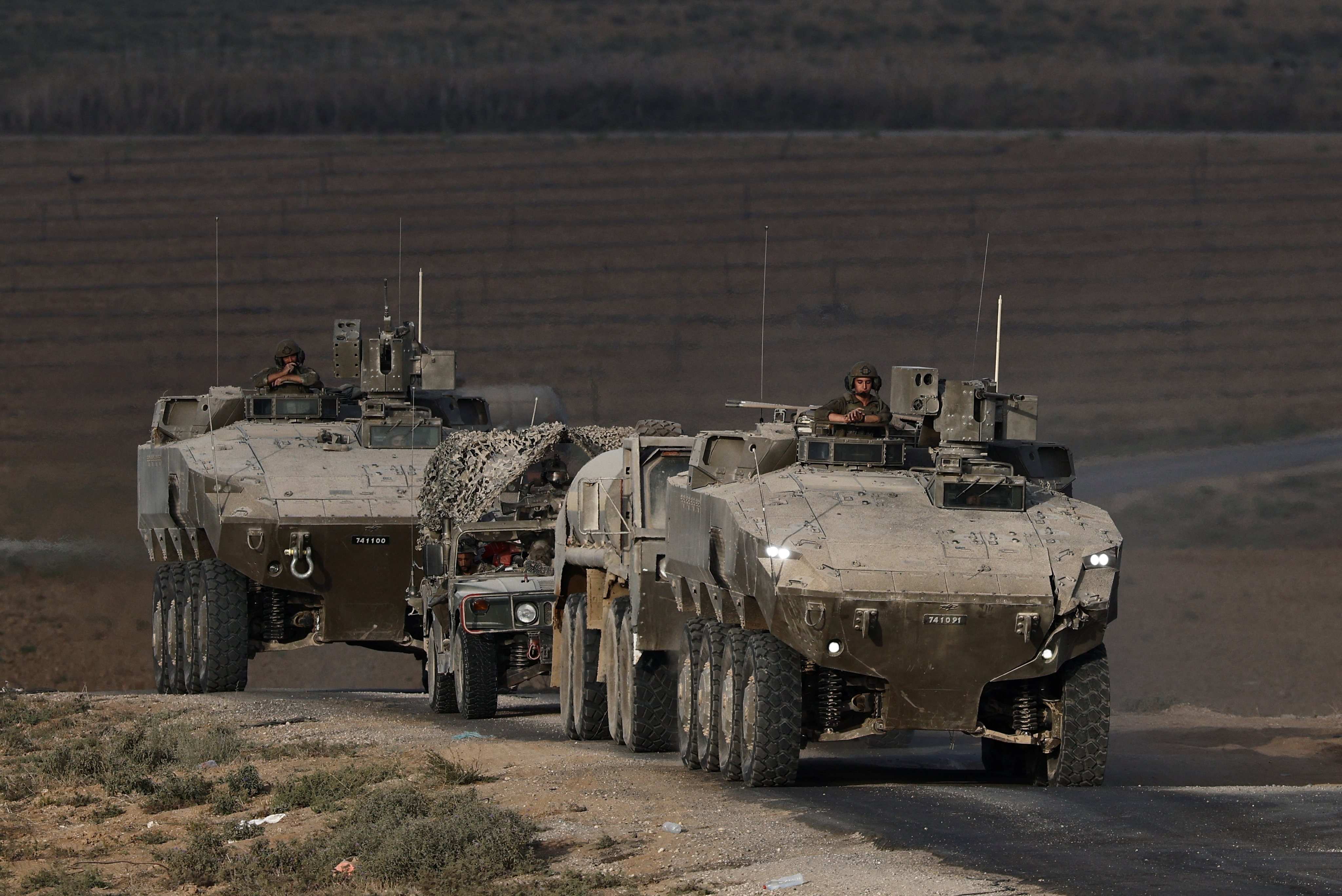 An Israeli military convoy manoeuvres on Israeli side of the Israel-Gaza border