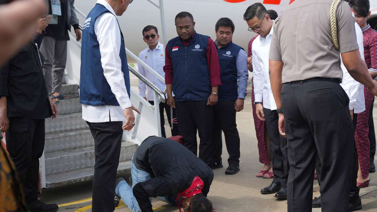 An Indonesian national rescued from Myanmar's scam centres reacts upon his arrival from Thailand, at Soekarno-Hatta International airport in Tangerang