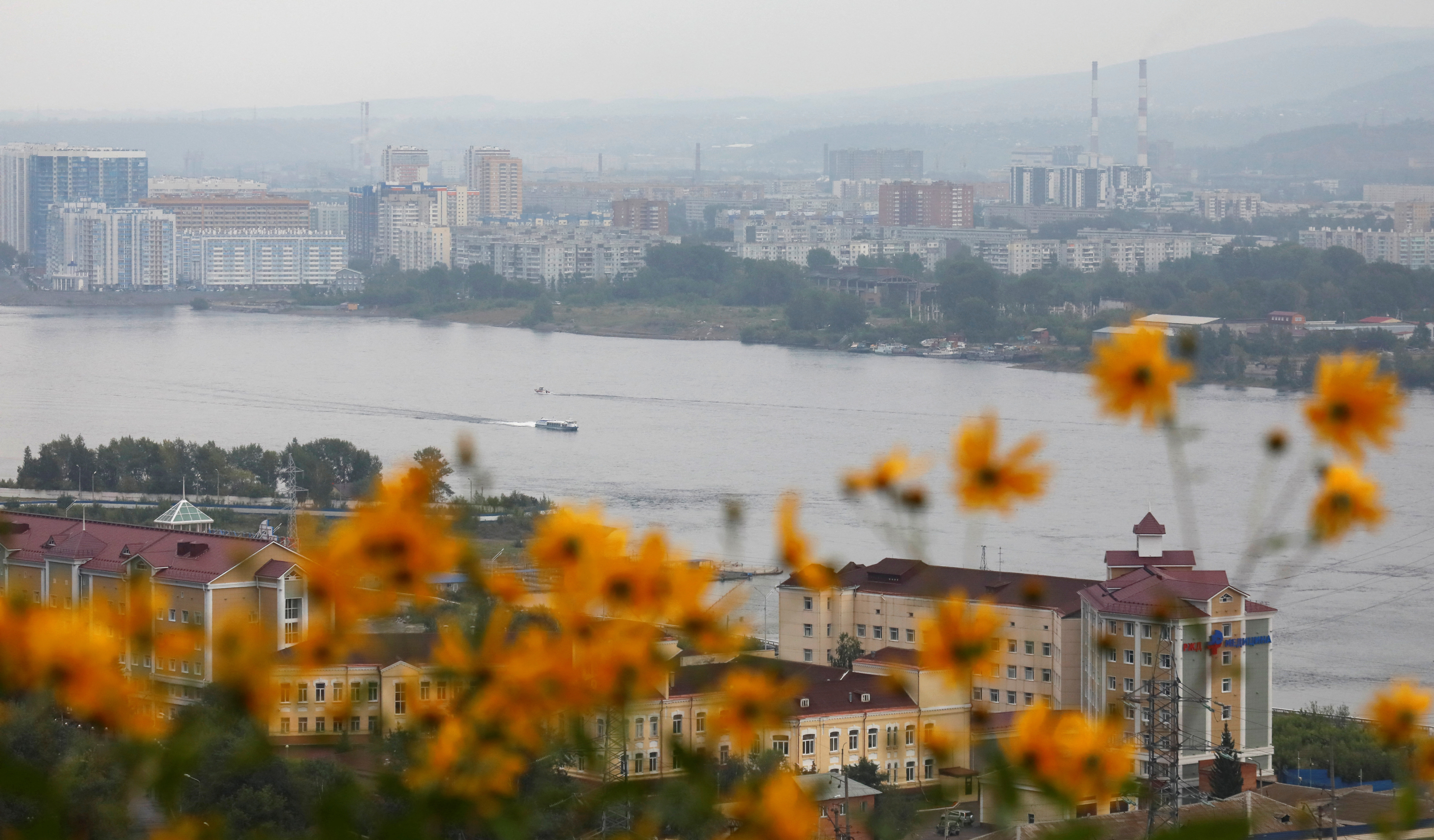 FILE PHOTO: Vessels sail along the Yenisei River in Krasnoyarsk