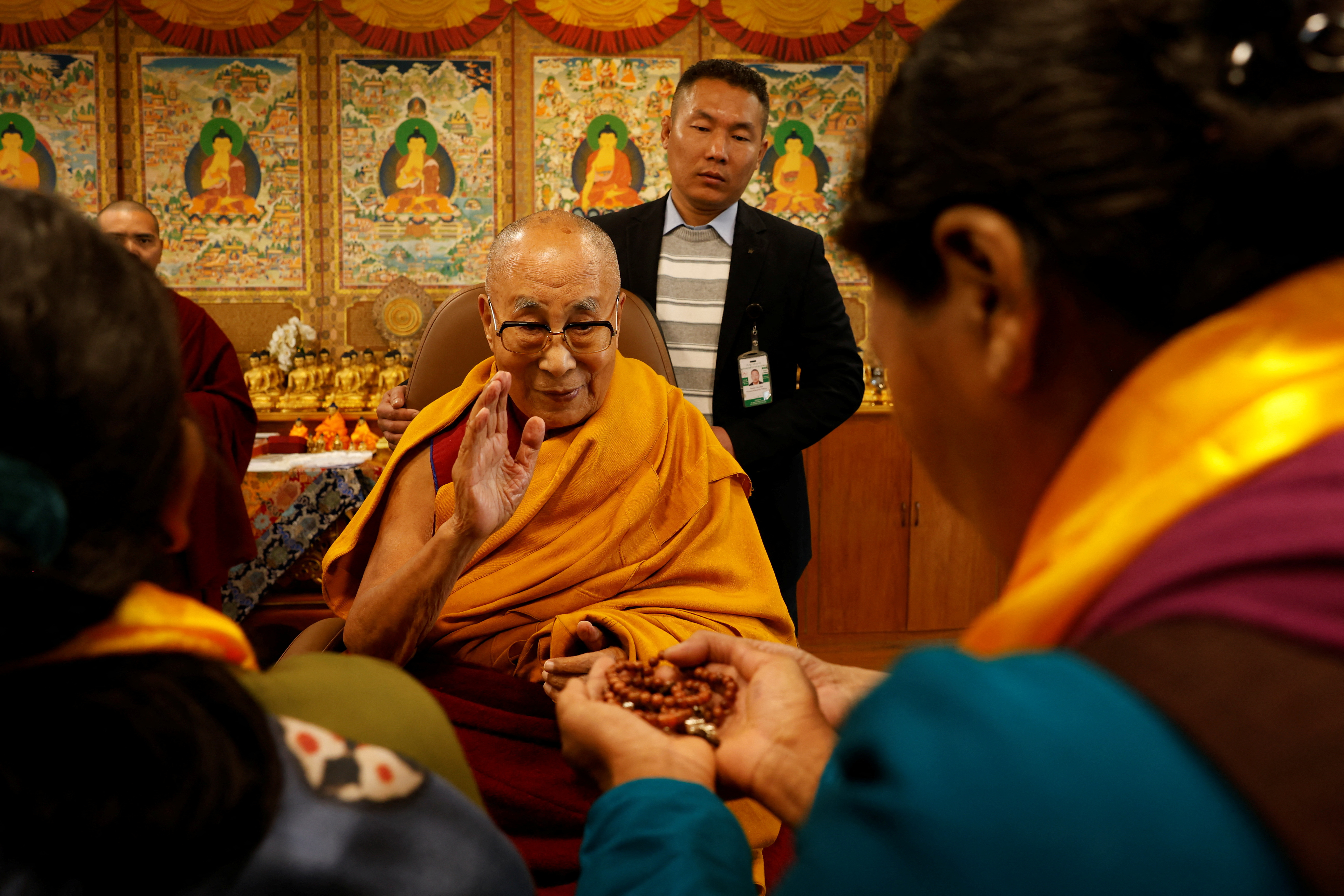 Tibetan spiritual leader, the Dalai Lama, offers blessings to his followers at his Himalayan residence in Dharamshala