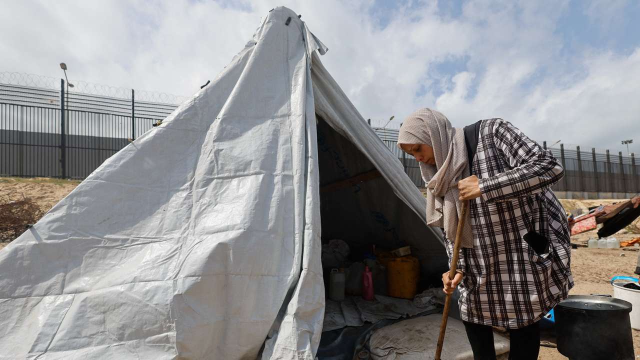 Displaced Palestinian women, who fled their houses due to Israeli strikes shelter in a tent camp, in Rafah