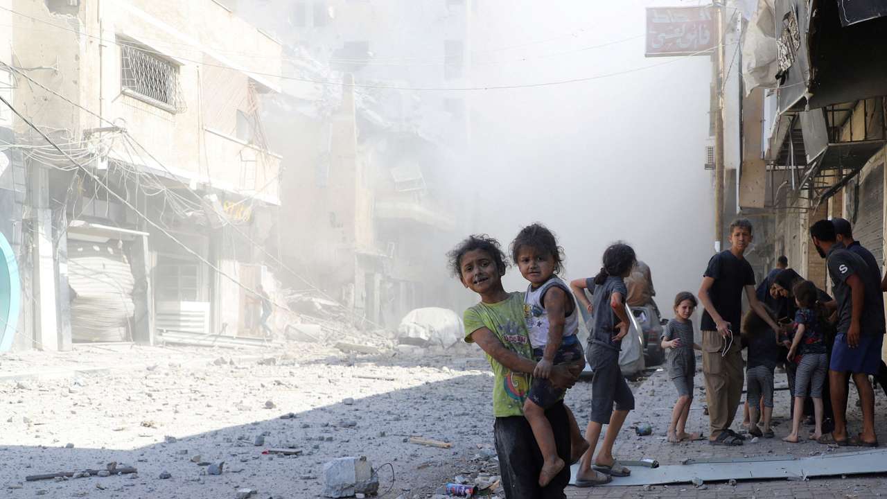 Palestinians inspect the site of Israeli strikes on a house, in Gaza City