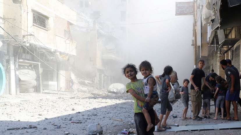 Palestinians inspect the site of Israeli strikes on a house, in Gaza City