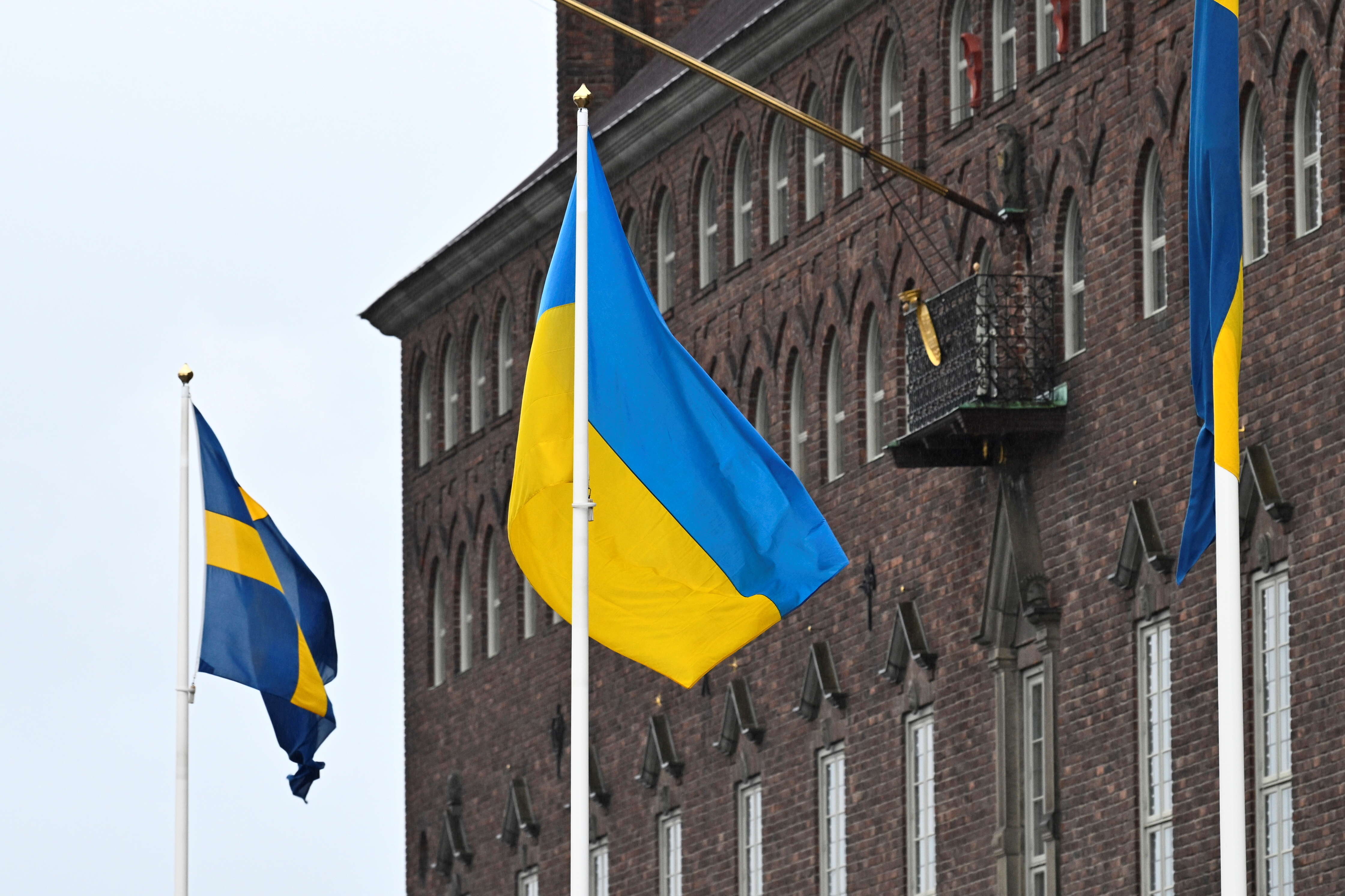 The flag of Ukraine waves in the wind at City Hall, in Stockholm