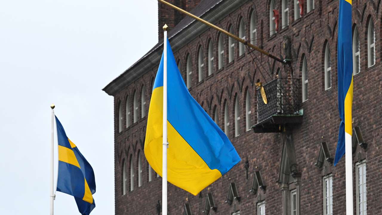 The flag of Ukraine waves in the wind at City Hall, in Stockholm