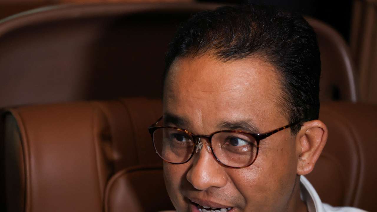 Former Jakarta Governor and presidential candidate Anies Baswedan speaks during an interview in a car in Tasikmalaya
