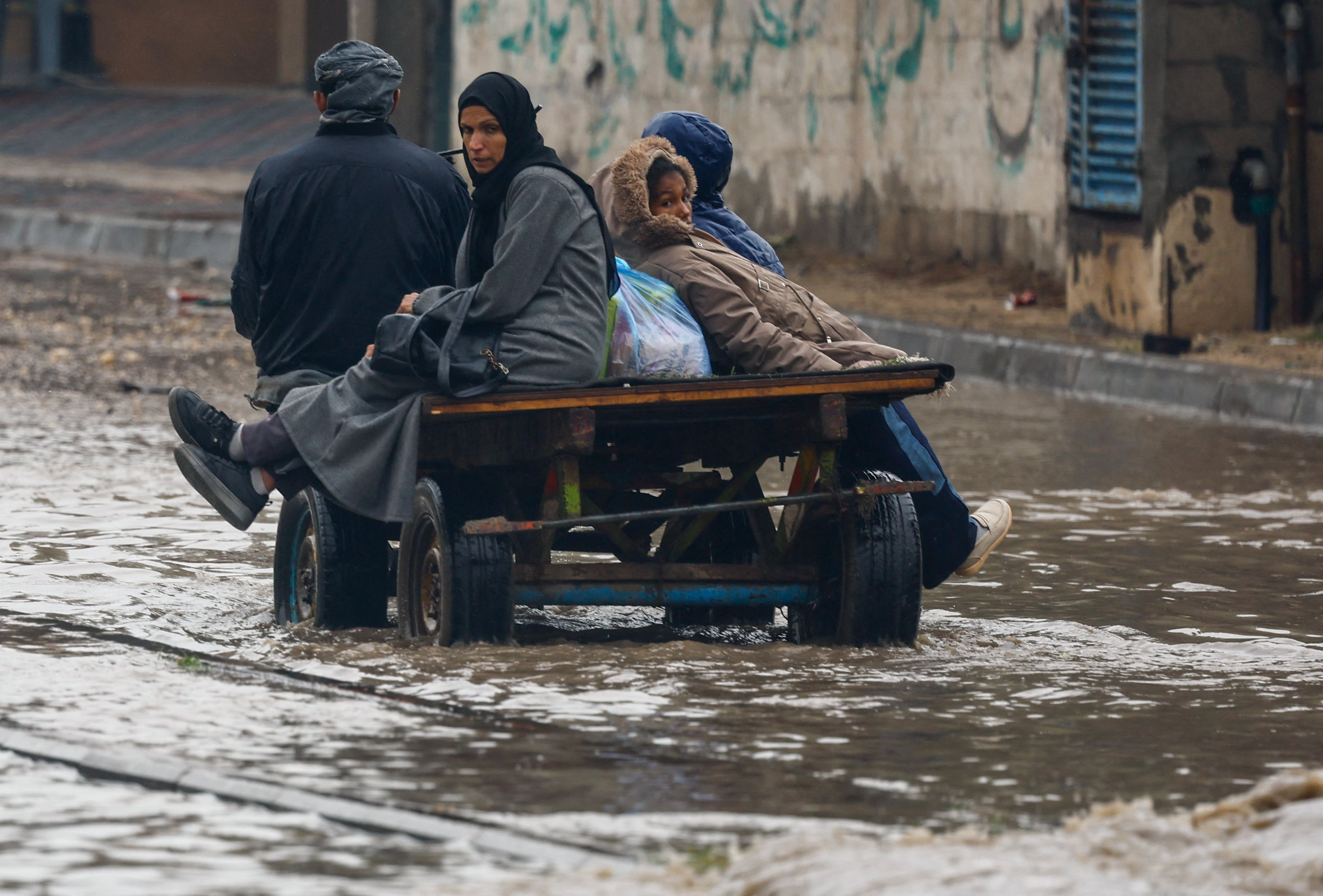 Displaced Palestinians shelter in a tent camp, on a rainy day in Nuseirat