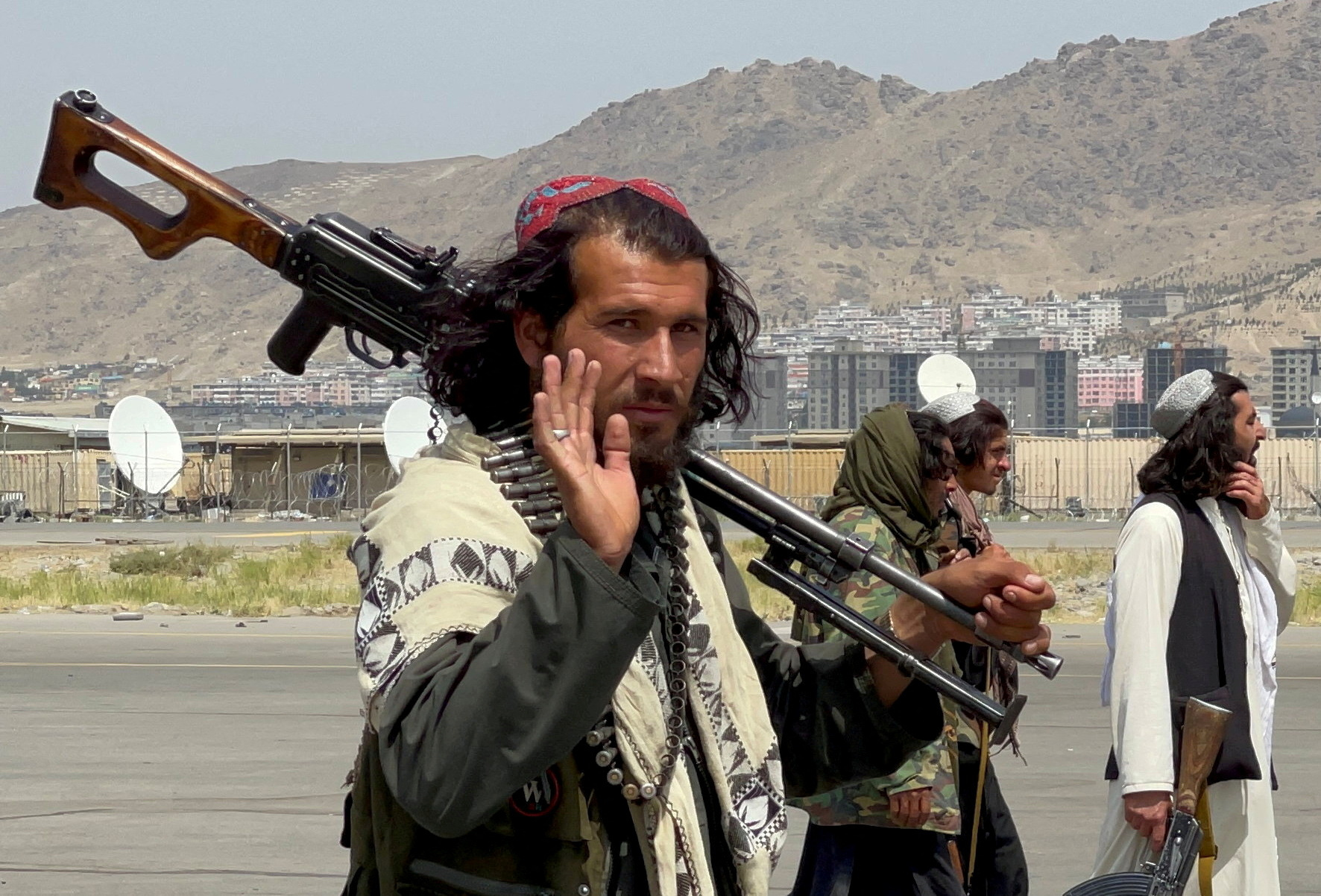FILE PHOTO: Taliban forces patrol a runway a day after U.S. troops' withdrawal from Hamid Karzai International Airport in Kabul
