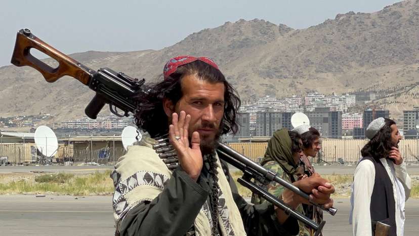 FILE PHOTO: Taliban forces patrol a runway a day after U.S. troops' withdrawal from Hamid Karzai International Airport in Kabul