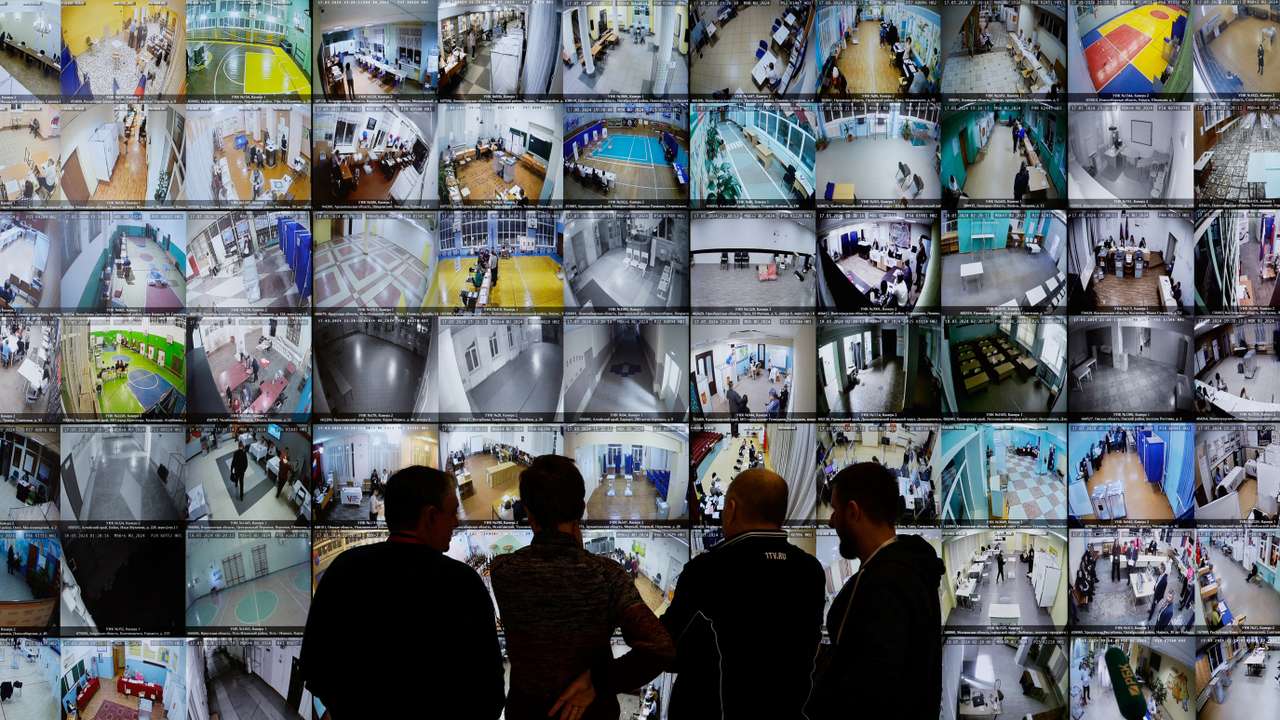 People look at the screens at the headquarters of Russia's Central Election Commission, in Moscow