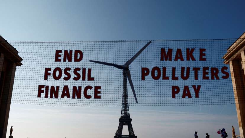 FILE PHOTO: Activists turn Eiffel Tower into giant wind turbine to welcome world leaders in Paris