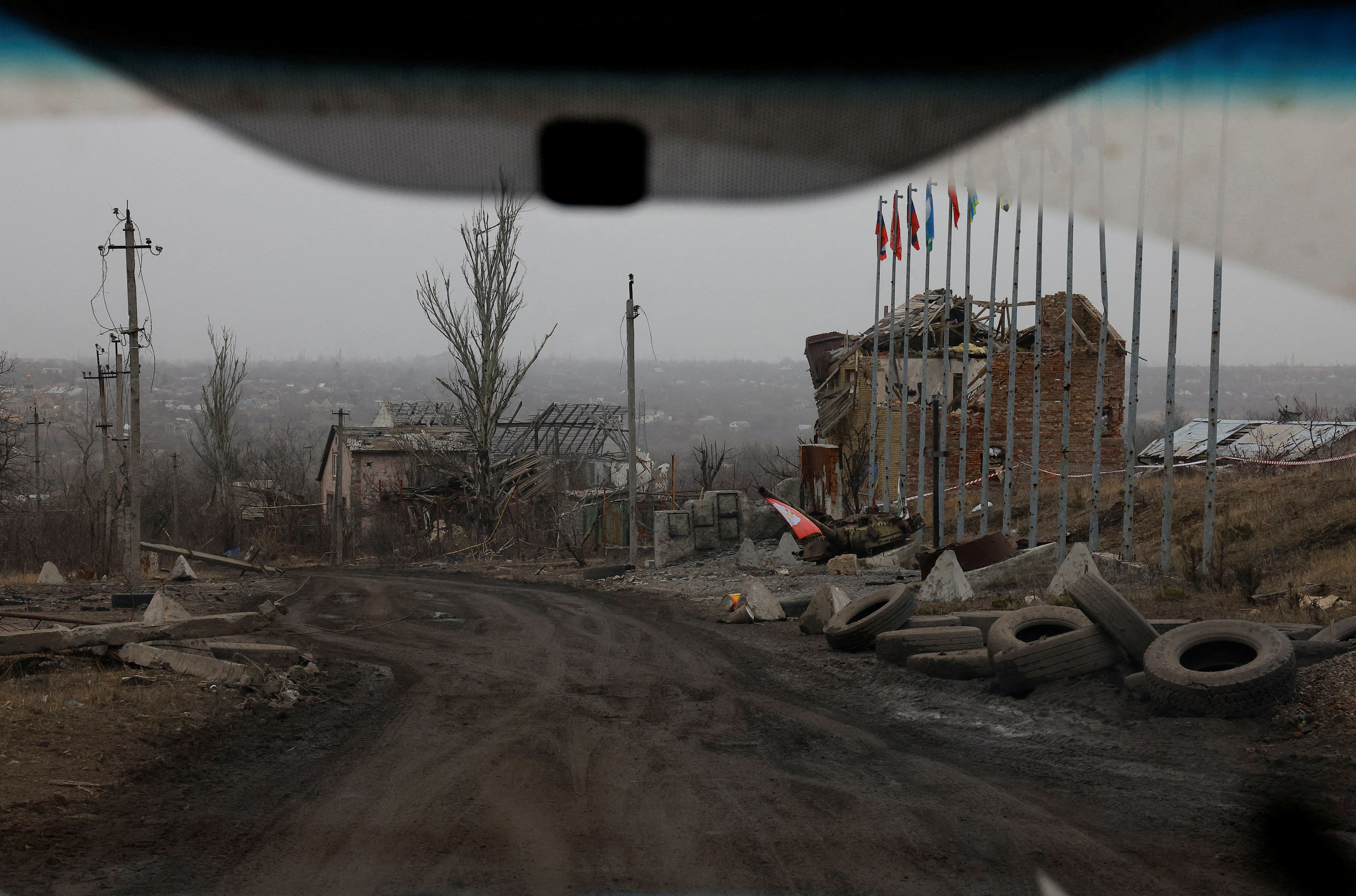 FILE PHOTO: A view from a car shows destroyed buildings in Avdiivka