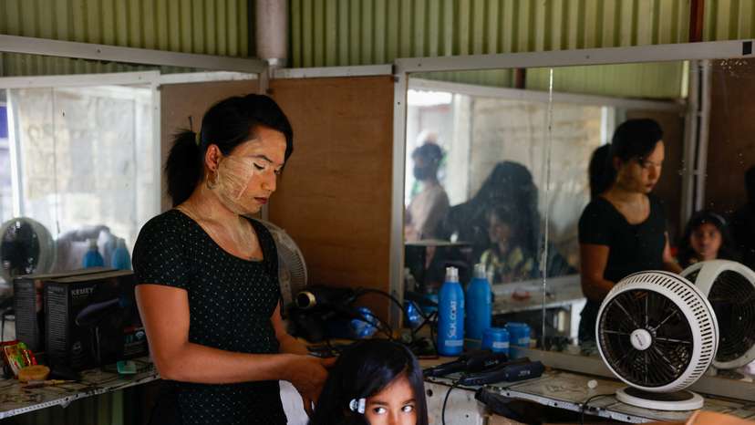 Tanya, 25, a Rohingya transgender beautician, provides service to a young girl in her beauty parlour, at the entrance of the Kutupalong refugee camp, in Cox's Bazar