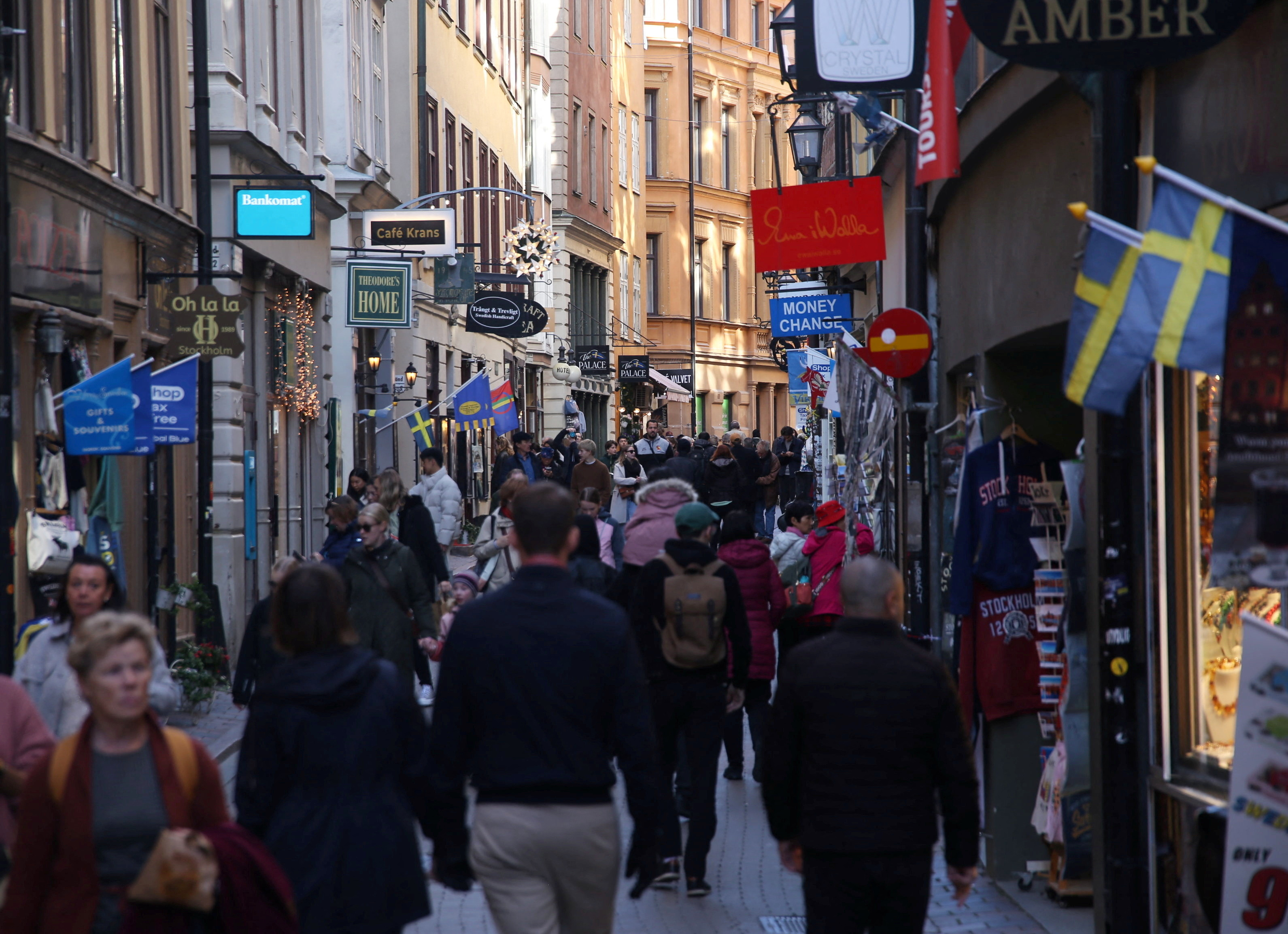 Pedestrians walk along a street in the Old Town of Stockholm