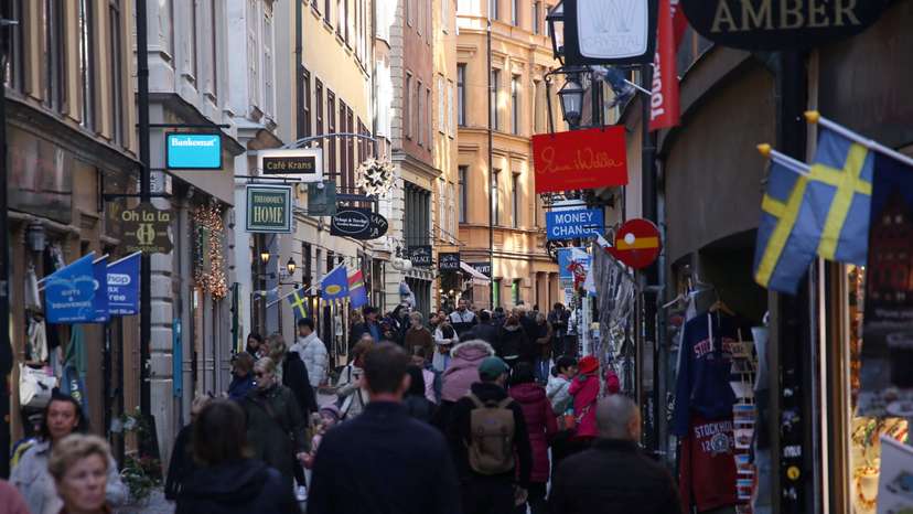 Pedestrians walk along a street in the Old Town of Stockholm