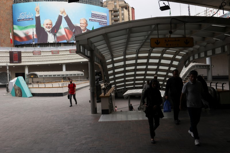 A billboard with a picture of late Hamas leader Ismail Haniyeh and Iran's President, Masoud Pezeshkian, is displayed on a building in Tehran