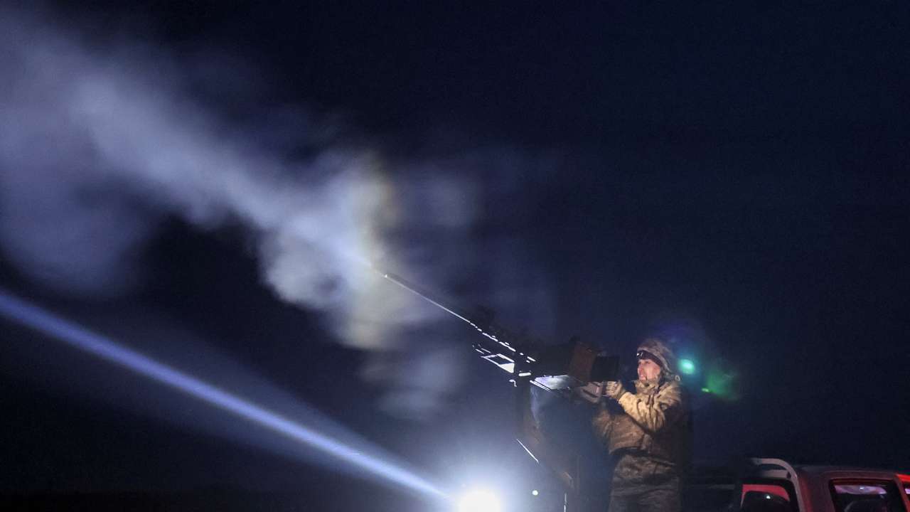 A Ukrainian serviceman from anti-drone mobile air defence unit fires a Browning machine gun at his position during combat in Chernihiv region