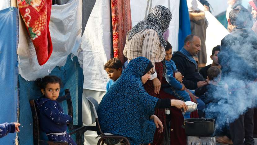 FILE PHOTO: Palestinians, who fled their houses amid Israeli strikes, shelter at a United Nations-run school, in Khan Younis