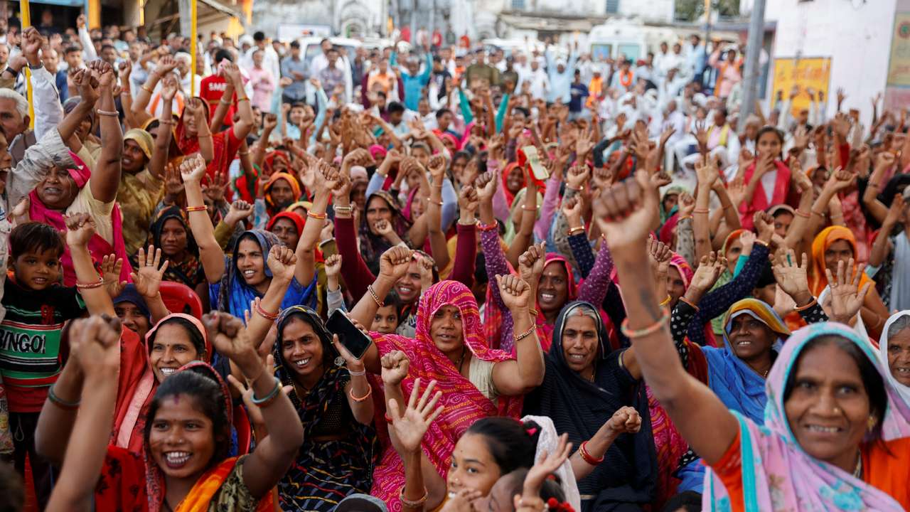 Women raise hands at an event where the senior Bharatiya Janata Party (BJP) leader Shivraj Singh Chouhan was visiting, in the village Ladkui near Bhopal